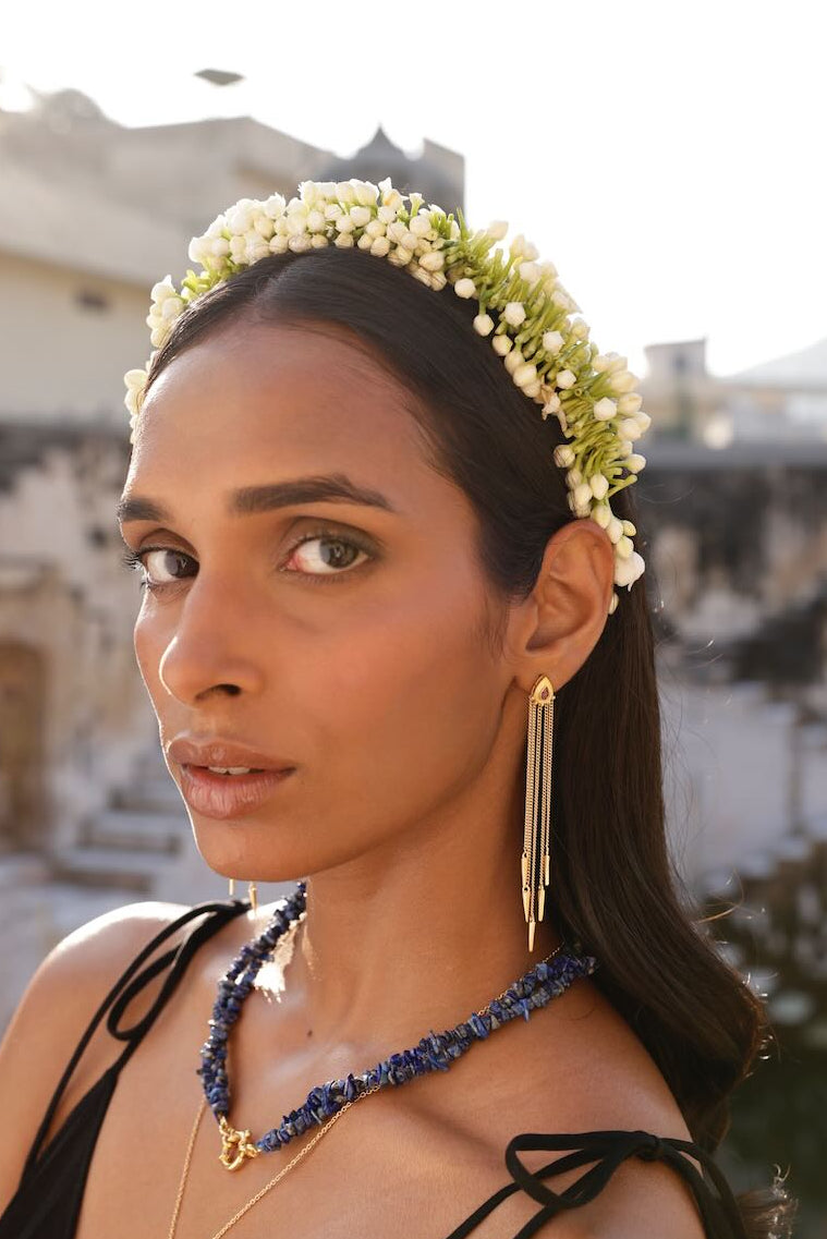Gold and ruby tassel drop earrings with arrows.  Lapis lazuli twist necklace.
